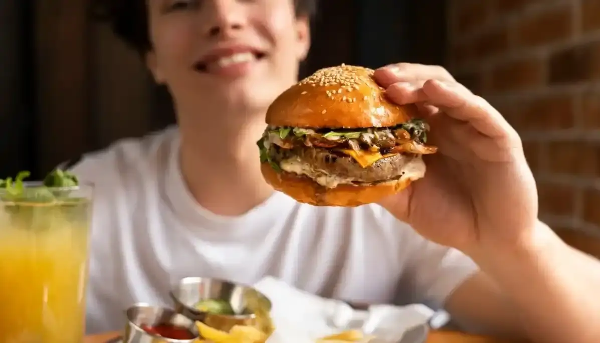 Woman smiling with a burger